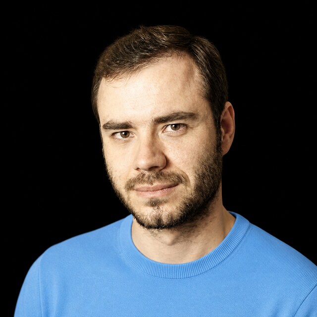AI-generated portrait of Andrej Karpathy wearing a DoomBench-blue top against a black background.