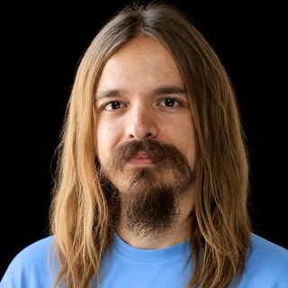 AI-generated portrait of Connor Leahy wearing a DoomBench-blue top against a black background.