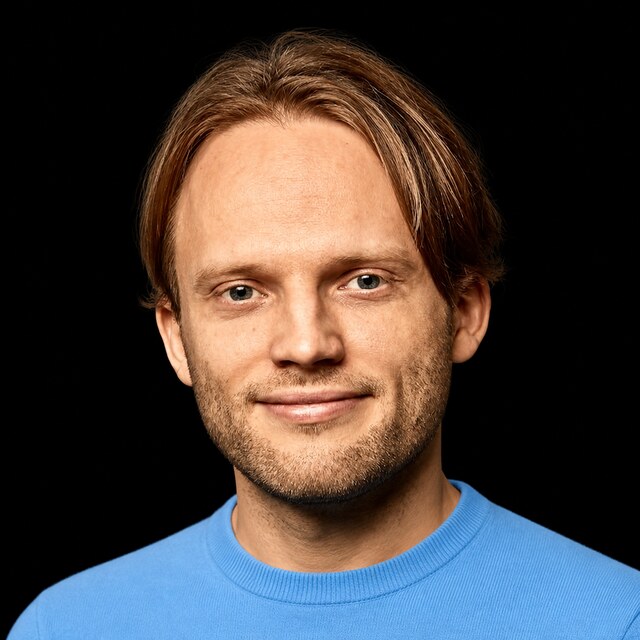 AI-generated portrait of Jan Leike wearing a DoomBench-blue top against a black background.