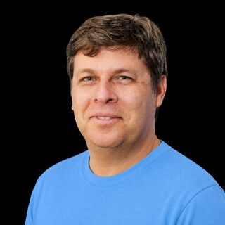 AI-generated portrait of Oren Etzioni wearing a DoomBench-blue top against a black background.