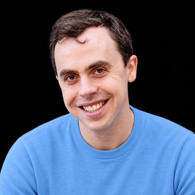 AI-generated portrait of Paul Christiano wearing a DoomBench-blue top against a black background.